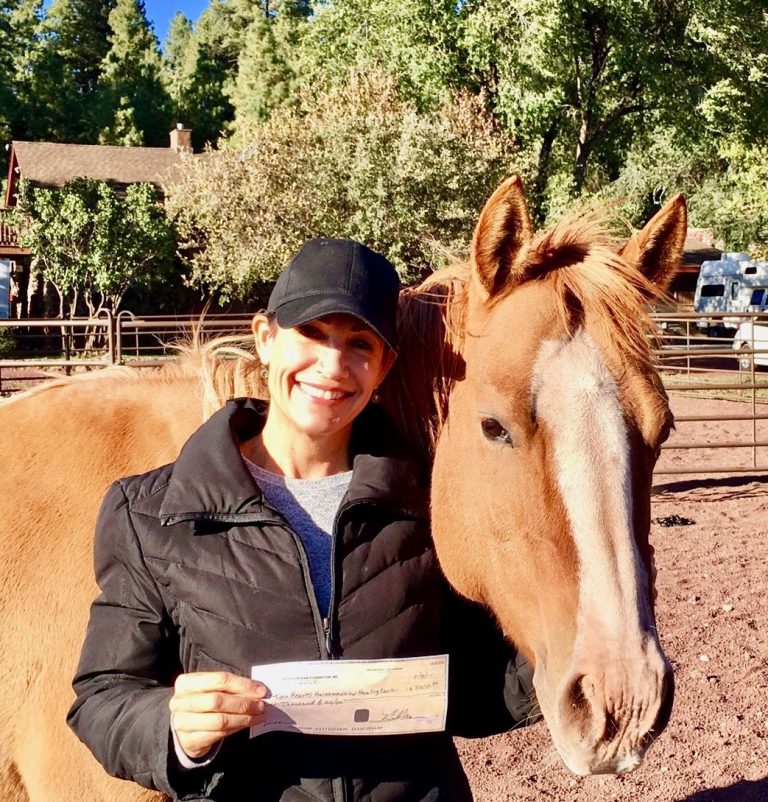 Cindy Jones, Director and owner of Two Hearts Horsemanship Healing Center, saying thanks for the check from the 50:50 Drawing