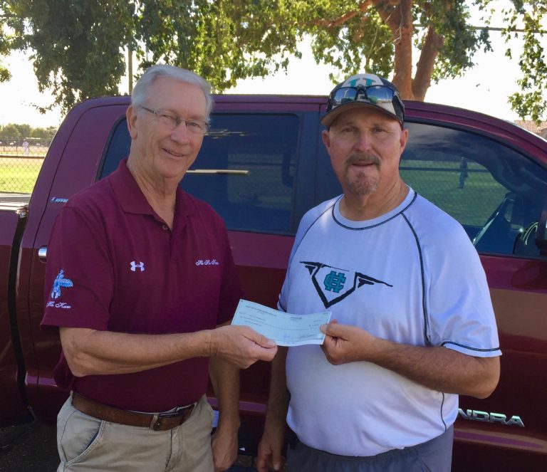 HoHoKam Member Charlie Deaton presents a check, from the HoHoKam Foundation, to Highland High School Baseball Coach Scott Cook