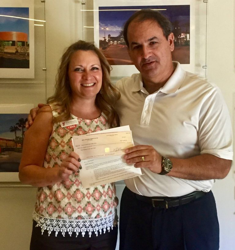 HoHoKam, Vince DiBella, presenting a check from the Mesa HoHoKam Foundation, to Sue Murawsky of The East Valley Family YMCA