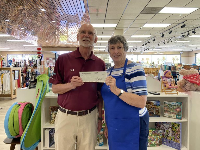 Mesa HoHoKam Big Ho, Mark Fullerton presents a check from 50:50 Raffle Cubs:Athletics HoHoKam Spring Training to Joyce Godfrey, Grant Writer and past President of Assistance League of the East Valley.