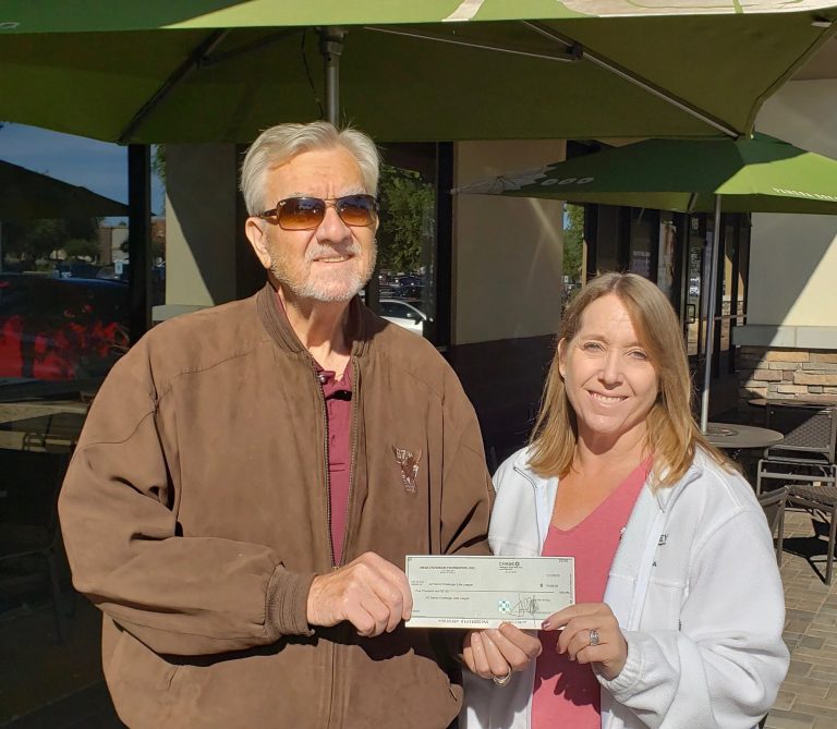 Mesa HoHoKam, George F. Bliss presents a check, from the Mesa HoHoKam Foundation, to Denise DeLage of the Challenger Little League