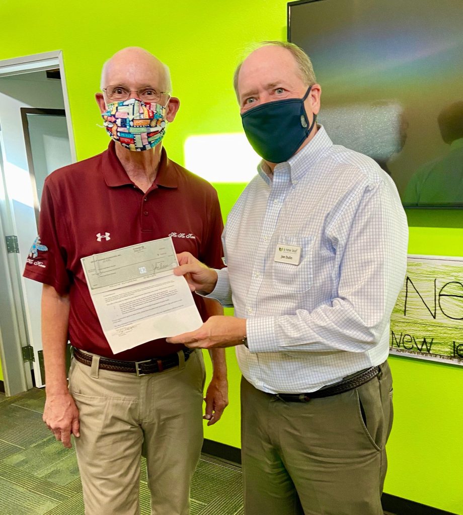 Mesa HoHoKam, Mark Fullerton, presents a check, from the Mesa HoHoKam Foundation to Jim Dulin, from The New Leaf's Men Shelter.