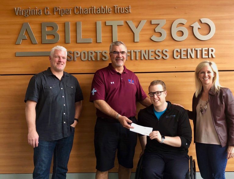 Mesa HoHoKam Member, John Dennett presents a check from The Mesa HoHoKam Foundation, to Meghan Fabel with The Ability 360 Sports Fitness Center.