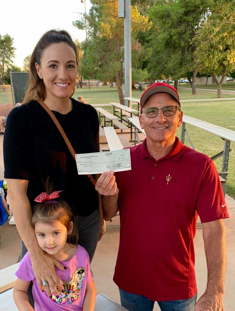 Mesa HoHoKam Neil Barna presents a check, from The HoHoKam Foundation to RSL San Tan AZ Soccer.