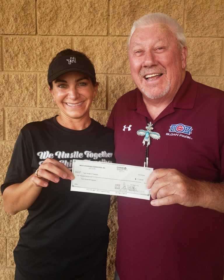 Mesa HoHokam Gary Whitley presents a check to Team Hustle Aguilar