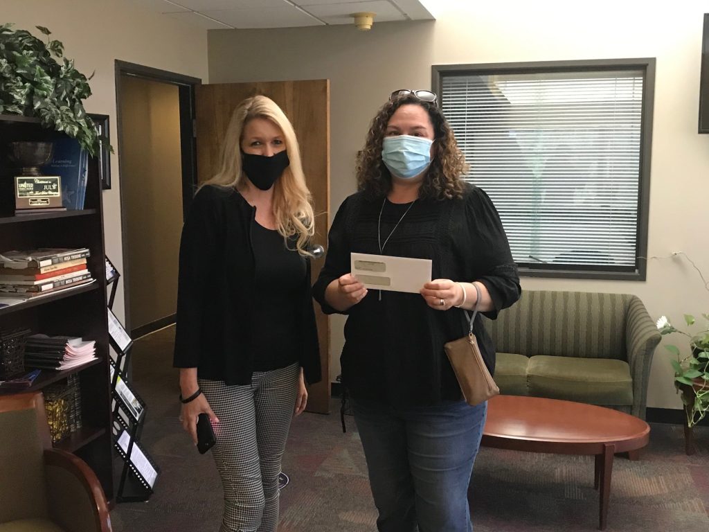 Mesa Hohokam, Sally Harrison, presented a check to Paulina Tiffany with Arizona Autism United (AZA United).
