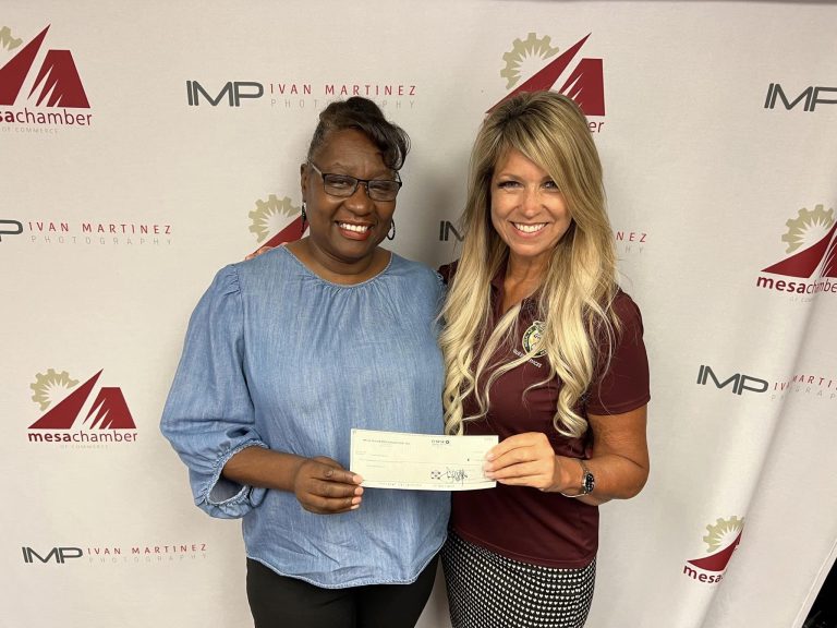 Mesa Hohokam, Sally Jo Harrison, presented Denise Anderson Carter, from the Non-Profit, Over-Flo Missions Inc., a check from the 50:50 Raffle 2022 Spring Training funds.