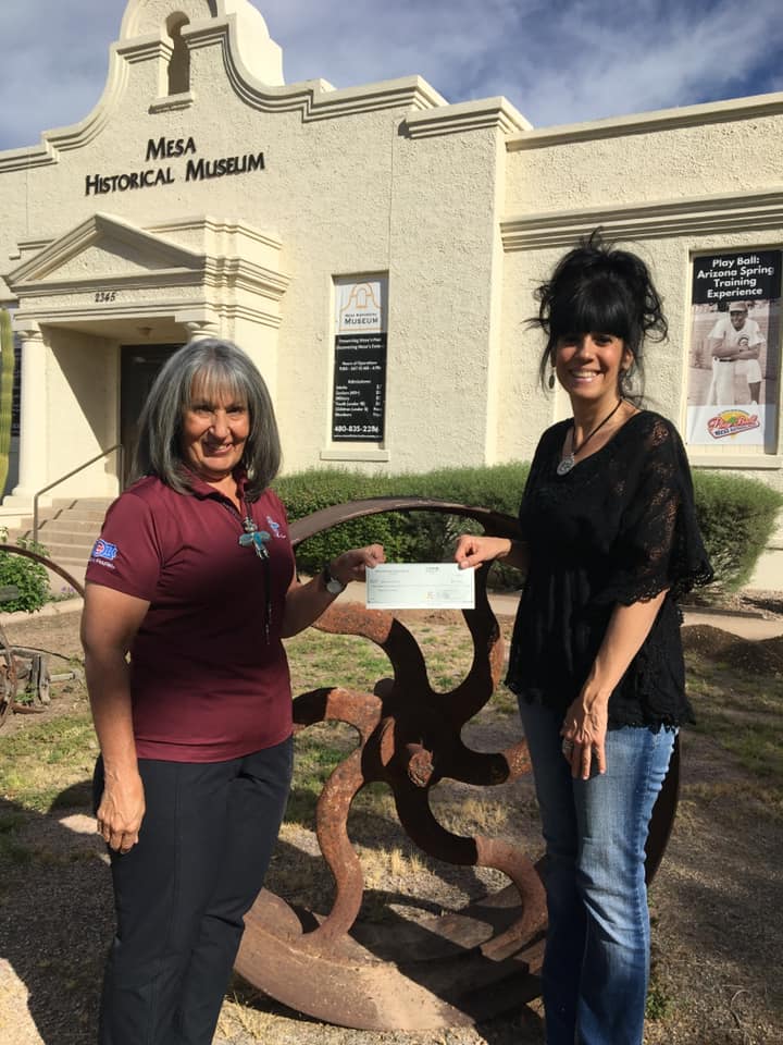 Susan Ricci, Executive Director of the Mesa Historical Museum gladly accepts a donation from the Mesa Hohokams