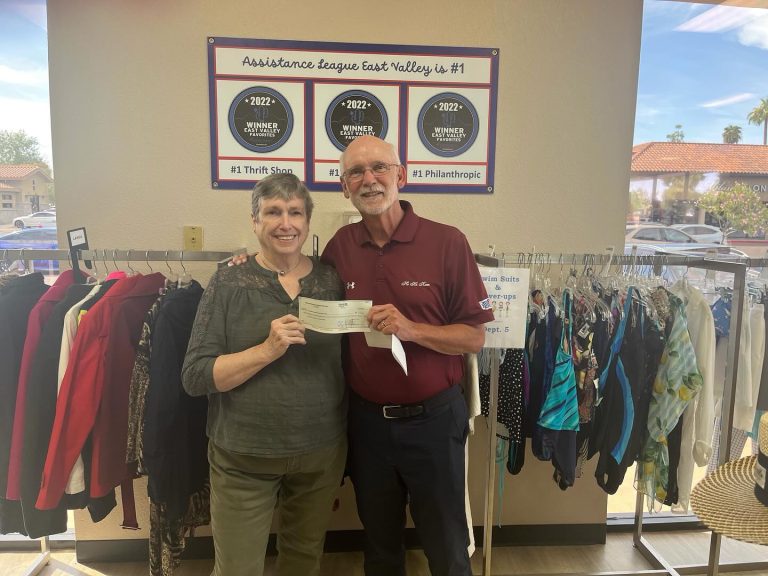 Mesa HoHoKam, Mark Fullerton delivers a 50/50 grant check to Joyce Godfrey of the Assistance League of The East Valley.