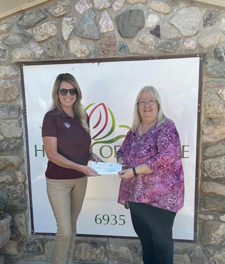 Mesa Hohokam member, Sally Jo Harrison, presented a grant check from the Hohokams spring training 50/50 sales, to House of Refuge CEO, Kayla Whiting Kolar.