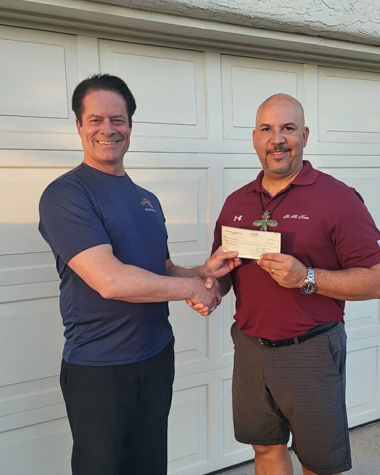 HoHoKam Board Member, Al Childress presents a grant check to Peter Means, Board Member of the McClintock High School Baseball Boosters.