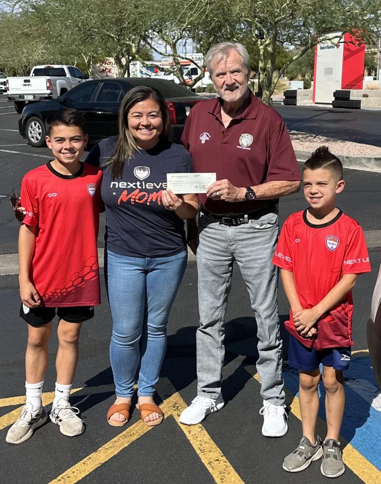 George F. Bliss presents a mesa HoHoKam Grant check from 50/50 Cubs/hoHoKam raffle to Erika Furgal for the East Valley Soccer Club.