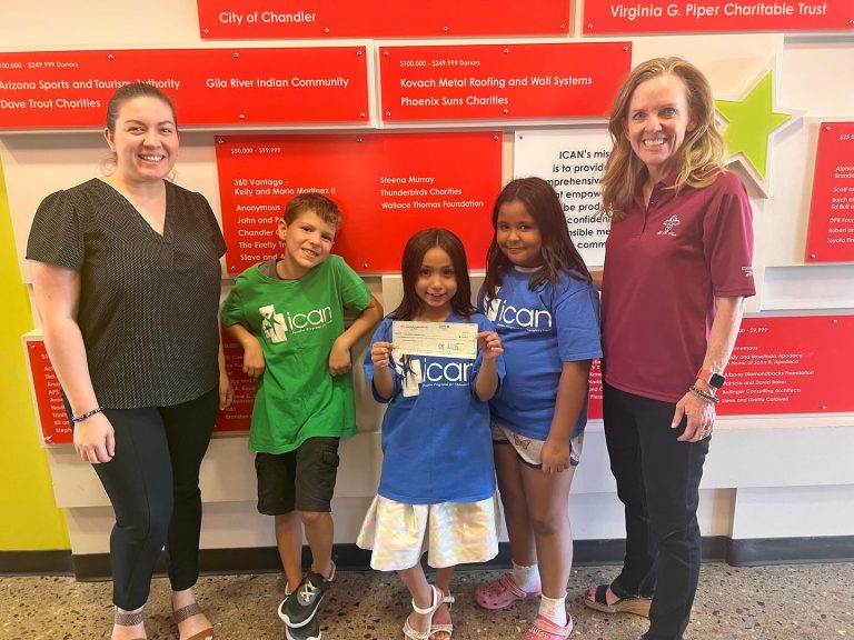 Mesa Hohokam member, Nicolle Karantinos, presents a check on behalf of the Mesa Hohokam 50/50 Grant Review Committee to ICAN's Community Engagement Coordinator, Sevde Haner, and some of their great ICAN students.