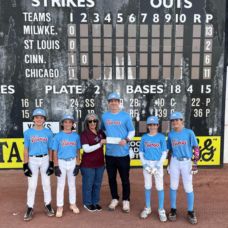 Anita Peters, member of the Mesa Hohokams presents a check to Rob Eagleston, vice president of the Red Mountain Little League.