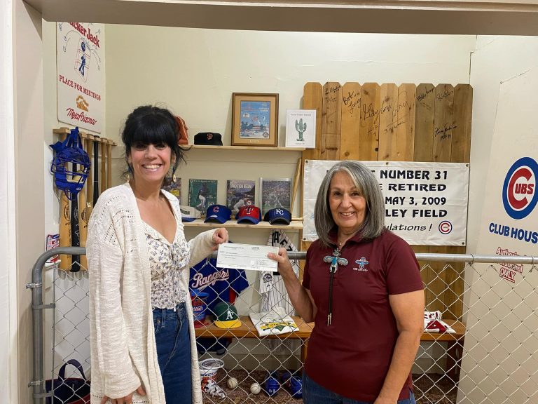 Anita Peters, Mesa HoHoKam member, giving a check to Susan Ricci, the Executive Director of the Mesa Historical Museum.