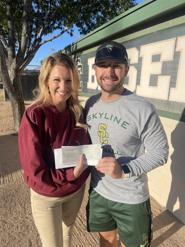 Mesa Hohokam member, Sally Jo Harrison, presented a check to Skyline Coyotes Baseball Booster Club coach Brian Gregory.