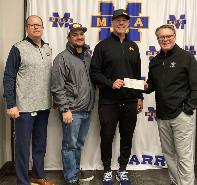 Steve Adams, Mesa HoHoKam, presents an award Grant to Chad DeGrenier, Head Coach of the Mesa High School Football team. Also present is David Klecka, Athletic Director and Josh Roberts, Assistant Coach. This program benefits approximately 175 youths by providing character building and service opportunities. These funds will be used for needed equipment and other needs of the program.