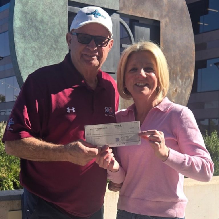 Mark Grant, Mesa Hohokam member, presents a 50/50 Raffle check to: Kathleen Hansen Board member  Our mission at Crowns of Courage is to provide halo wigs to pediatric cancer patients undergoing chemotherapy at no cost to the family, with the goal of alleviating the fear and reducing the trauma of chemotherapy-related hair loss.