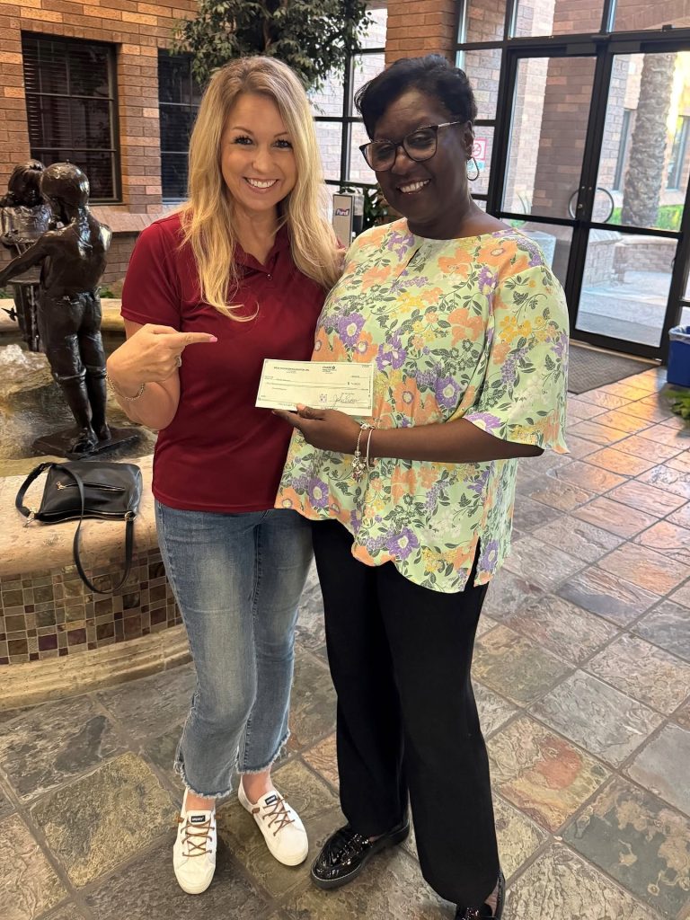 Over-Flo Missions Over-Flo Missions Director Denise Carter with Mesa HoHoKam Sally Harrison. The organization provides meals, water, hygiene supplies, and other resources to individuals and families in need.