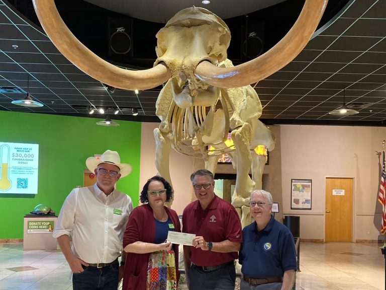 Arizona Museum of Natural History Foundation Mesa HoHoKam Steve Adams presented a 50/50 grant to Foundation VP Kaci Lint, Museum Director Simon Tipene Adlam, and Foundation Development Chair Dennis Kavanaugh. The funds support hands-on, educator-led STEM programs for K–12 students.