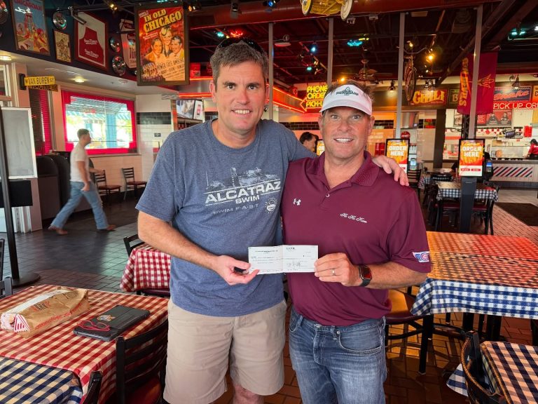 Neptune Swim Foundation Mesa HoHoKam Kent Nichols presented a grant to Joe Zemaitis of the Neptune Swim Foundation. The organization provides financial assistance to young swimmers for training and competition.