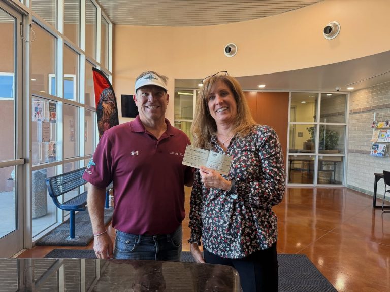Mesa Parks and Recreation Mesa HoHoKam Kent Nichols presented a grant to Ammie Mantis of Mesa Parks and Recreation. The funds help children in need participate in youth sports programs.