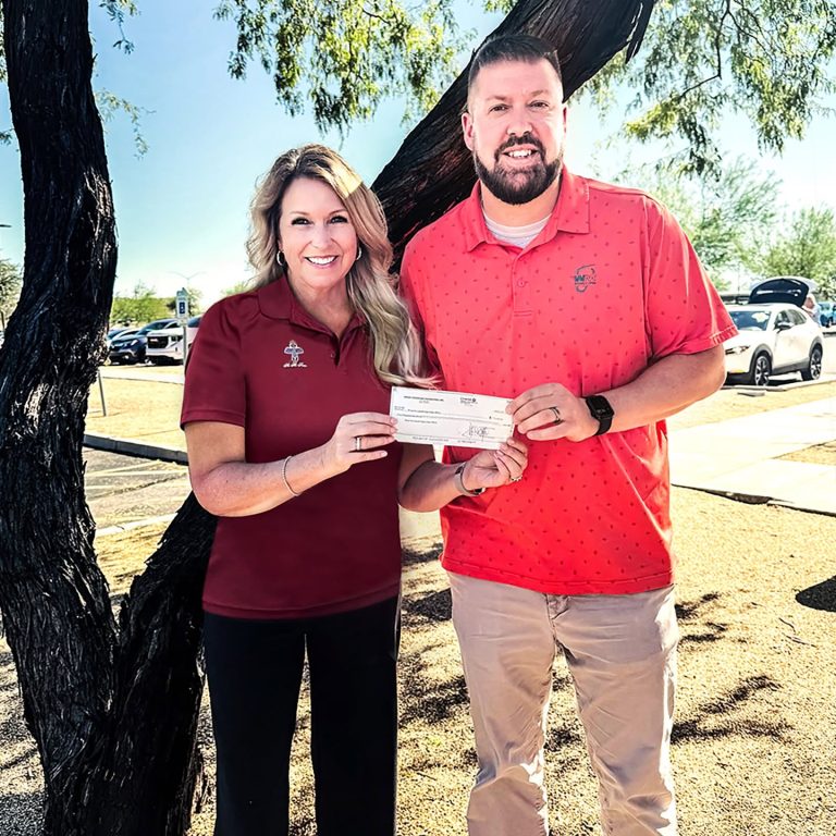 Ross Farnsworth East Valley Family YMCA Mesa HoHoKam Sally Harrison presented a Youth Sports Grant to Greg Bouslog of the Ross Farnsworth East Valley Family YMCA. The YMCA provides youth sports, fitness, childcare, and community programs for East Valley families.