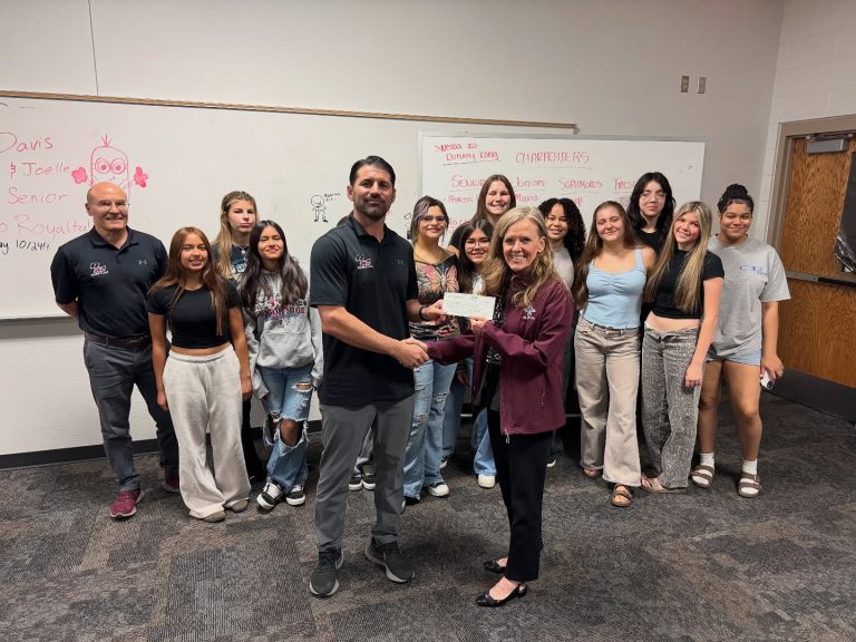 Red Mountain High School Girls Wrestling Mesa HoHoKam Nicolle Karantinos presented a Foundation grant to the Red Mountain Girls Wrestling program, including Coach Hawes, Coach Karantinos, and team members. The grant supports the program and its student-athletes.