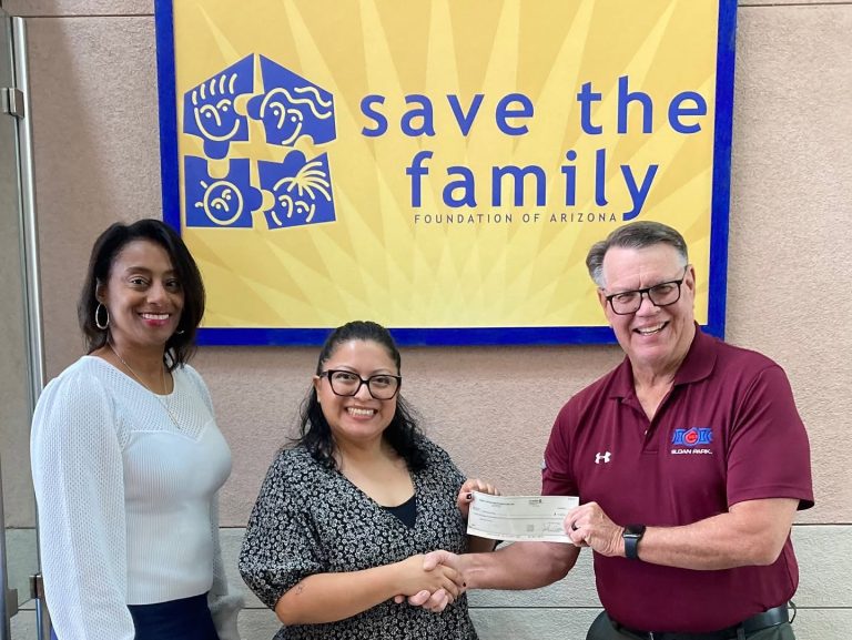 Save the Family Mesa HoHoKam Steve Adams presented a 50/50 Raffle Grant to Save the Family Grants Administrator Yesenia Gonzalez, joined by Chief Philanthropy Officer Mesha Davis. The grant supports services for children and families experiencing homelessness and poverty.